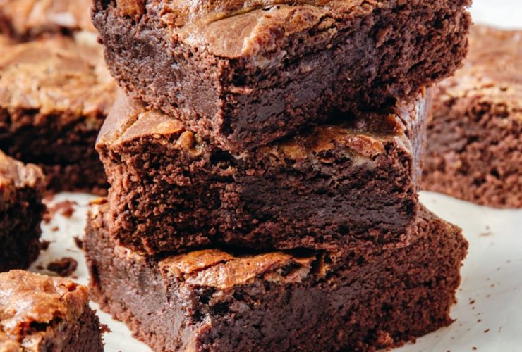 a pile of brownies sitting on top of a white plate