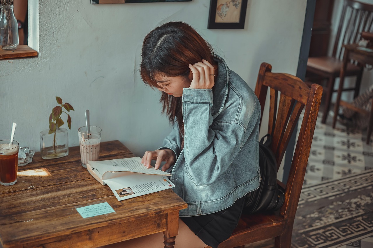 Vrouw die rustig schrijft in een notitieboekje in een gezellig café, als symbool voor bewuste zelfreflectie