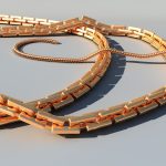 Gouden zomerse sieraden zoals schakelkettingen en enkelbandjes op een strandhanddoek