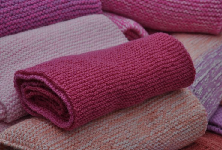 Netjes opgevouwen wollen en kasjmieren truien in zachte kleuren, klaar voor het najaar